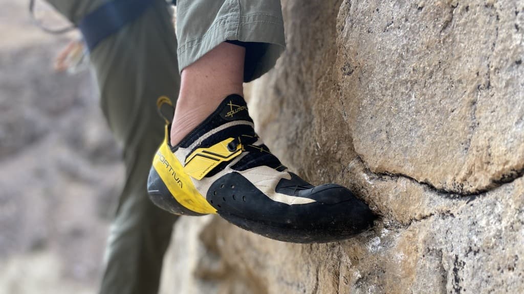 Aggressive climbing shoes on a steep overhang, ideal for advanced bouldering and sport climbs.